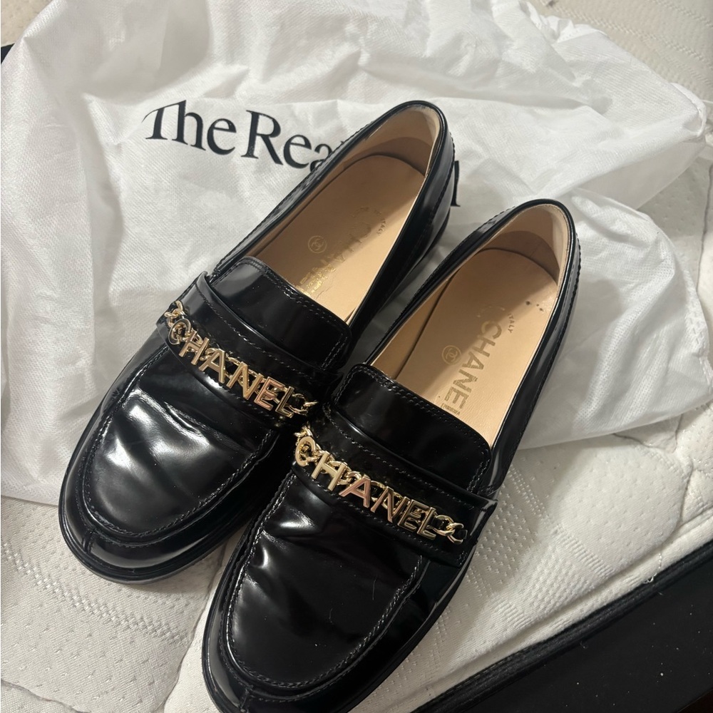 CHANEL Glossy Black Loafers with Gold Accent